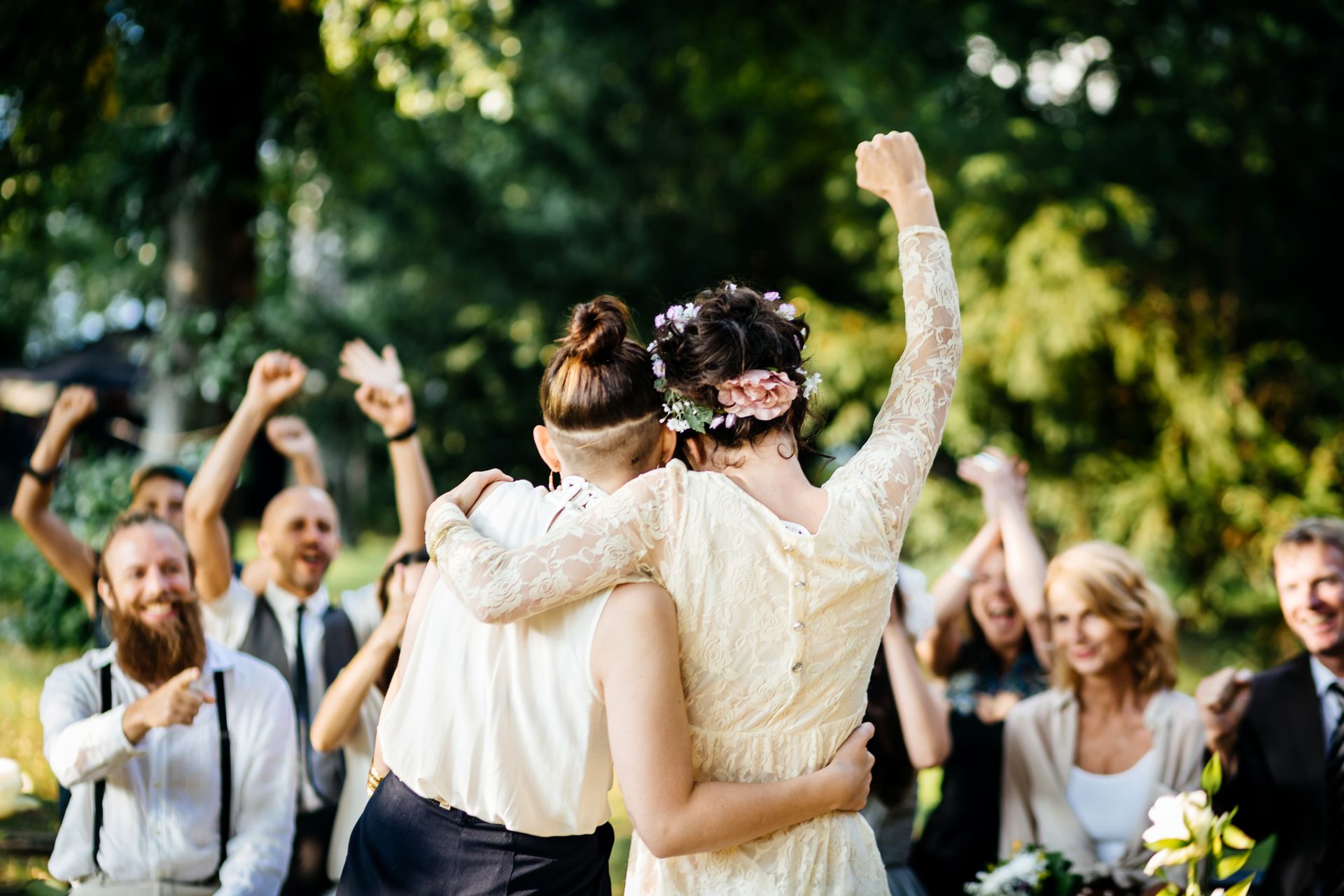 Couple cheered by guests at a garden wedding ceremony